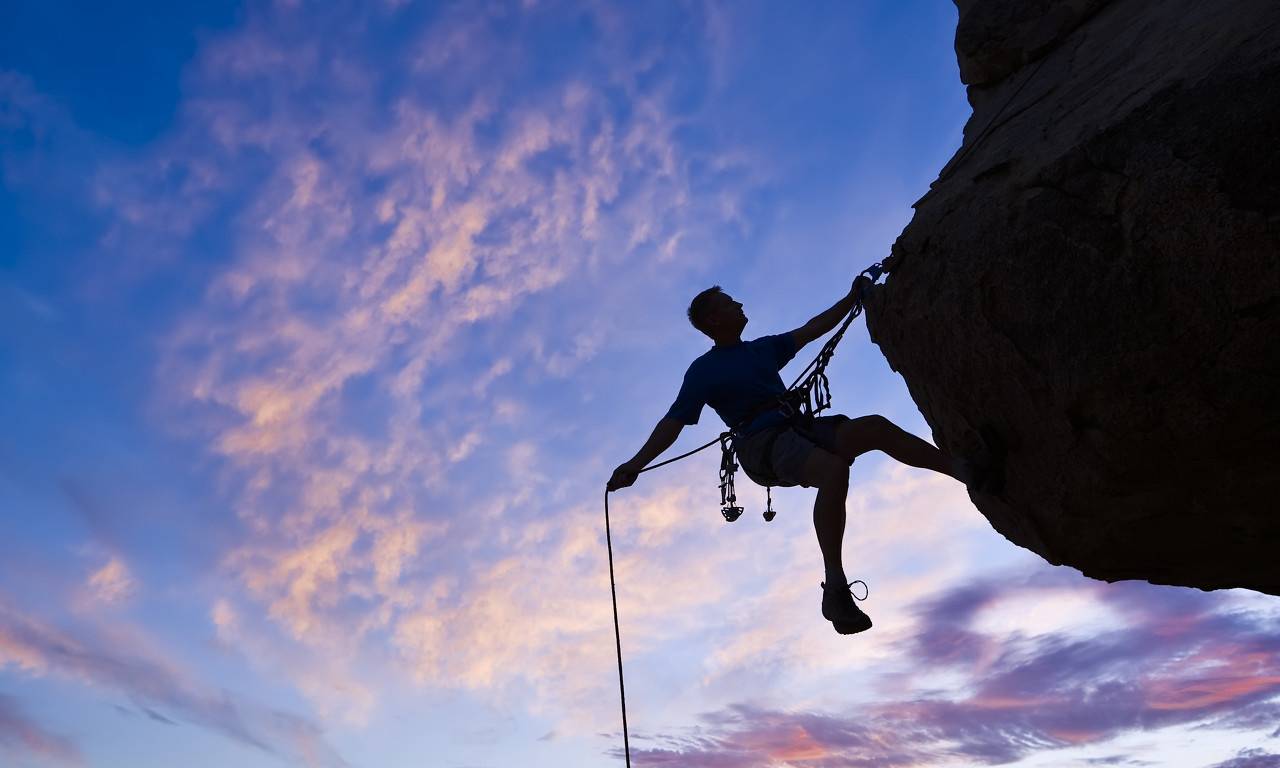 Rock climber rappelling.